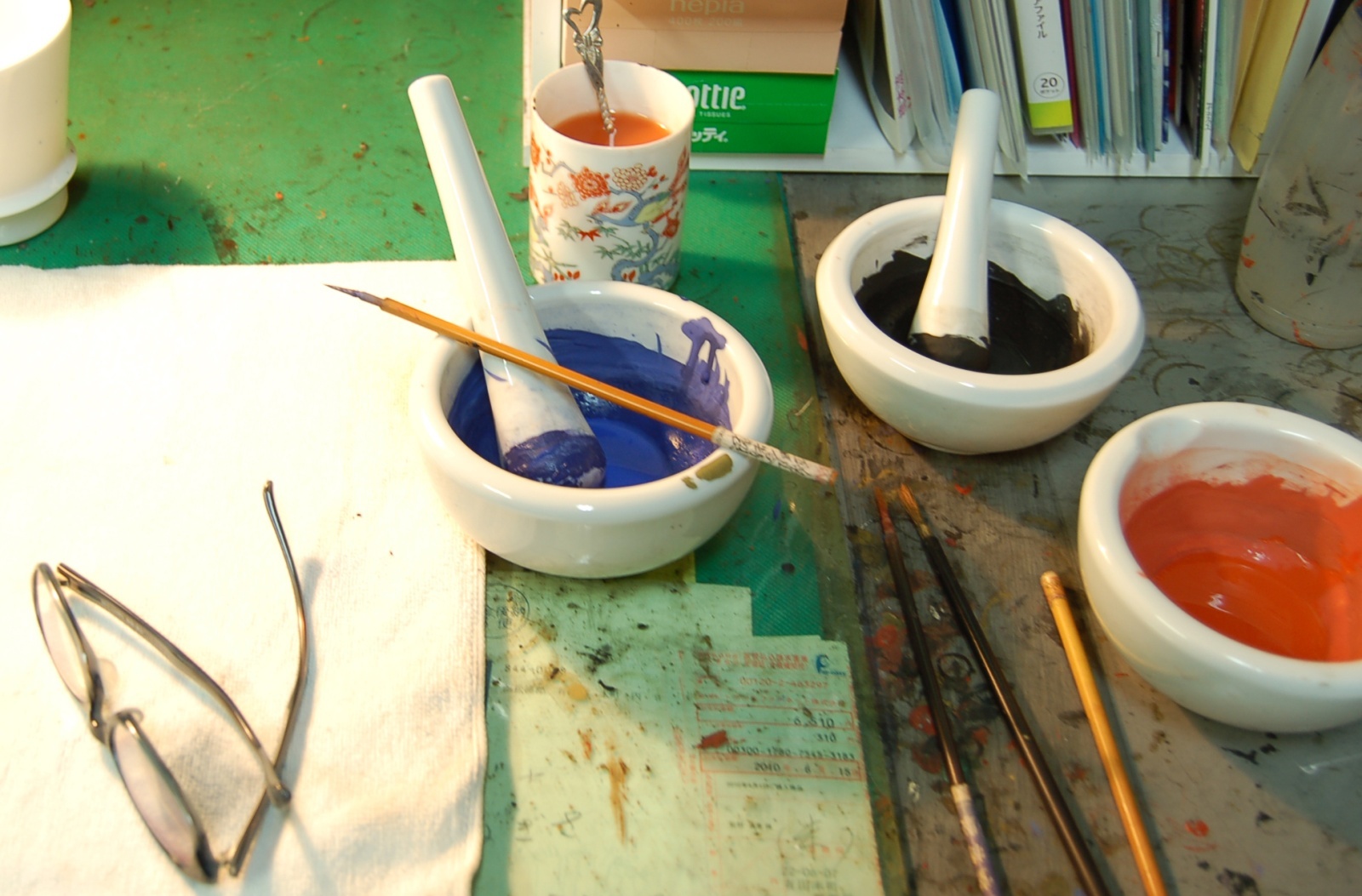 Akae overglaze enamels at a painting workstation