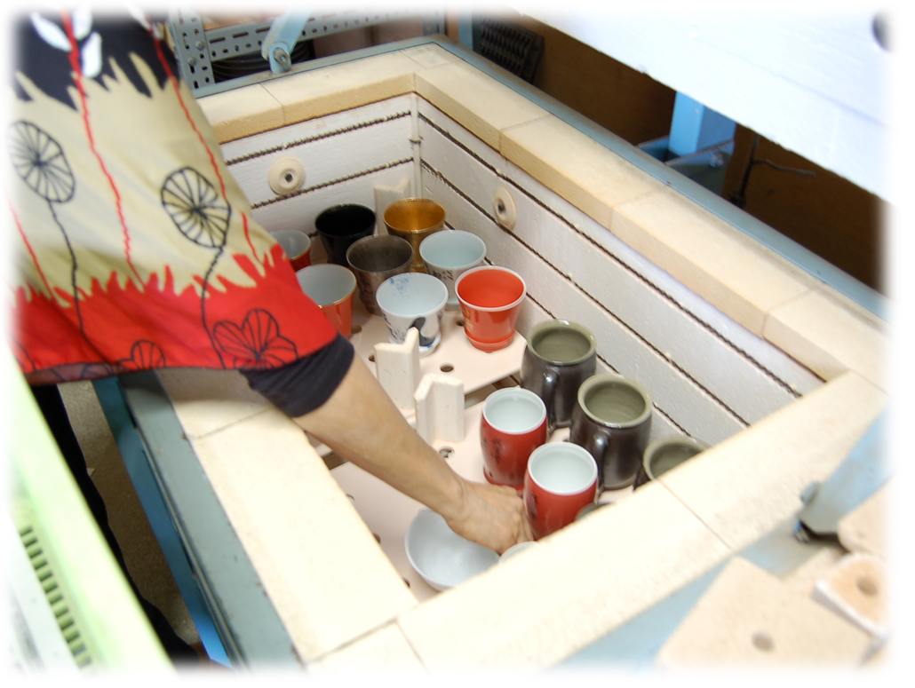 Ceramic pieces being loaded into an Akae enamel kiln