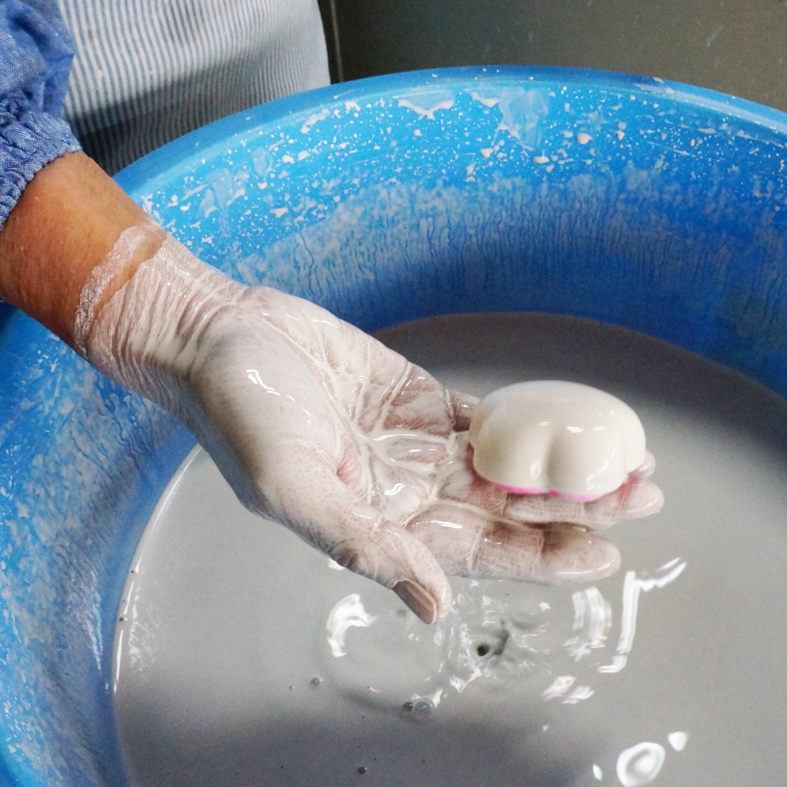 Ceramic ware being coated with glaze