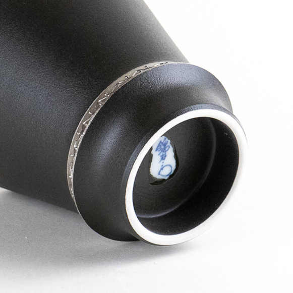 Unglazed white foot of a black porcelain cup